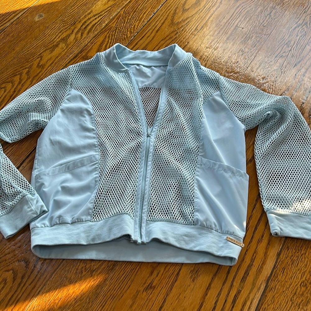 Mira Rae light blue zip front athletic jacket.Open weave net details, Size 12/13